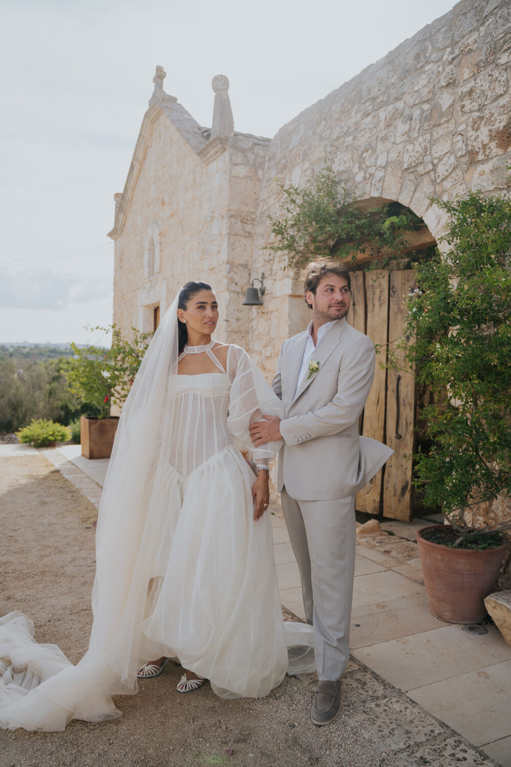 Masseria San Paolo Grande Wedding: Yasemin & Omer's Ostuni Celebration 1 Yasemin and Omer wedding portrait beside the estate's stone chapel at Masseria San Paolo Grande