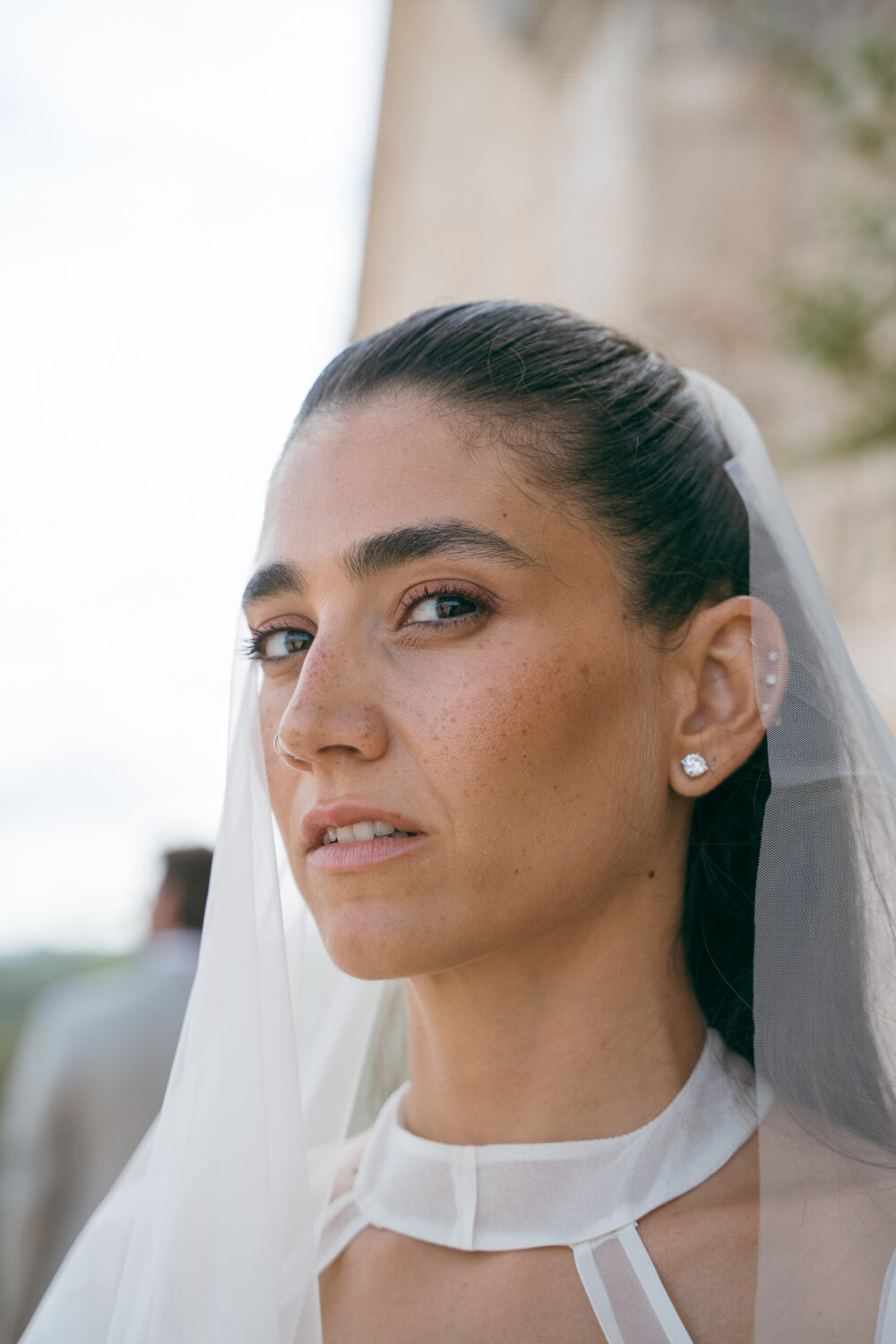 Masseria San Paolo Grande Wedding: Yasemin & Omer's Ostuni Celebration 47 Detail of the couple's wedding-day portraits near the estate's stone archway