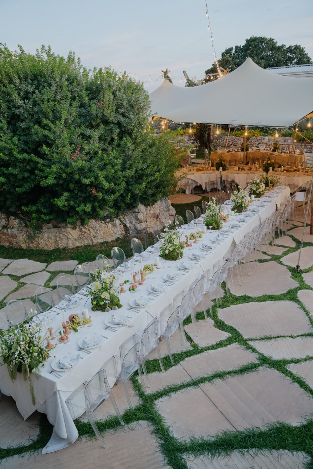 Masseria San Paolo Grande Wedding: Yasemin & Omer's Ostuni Celebration 25 Long reception table set under string lights at Masseria San Paolo Grande