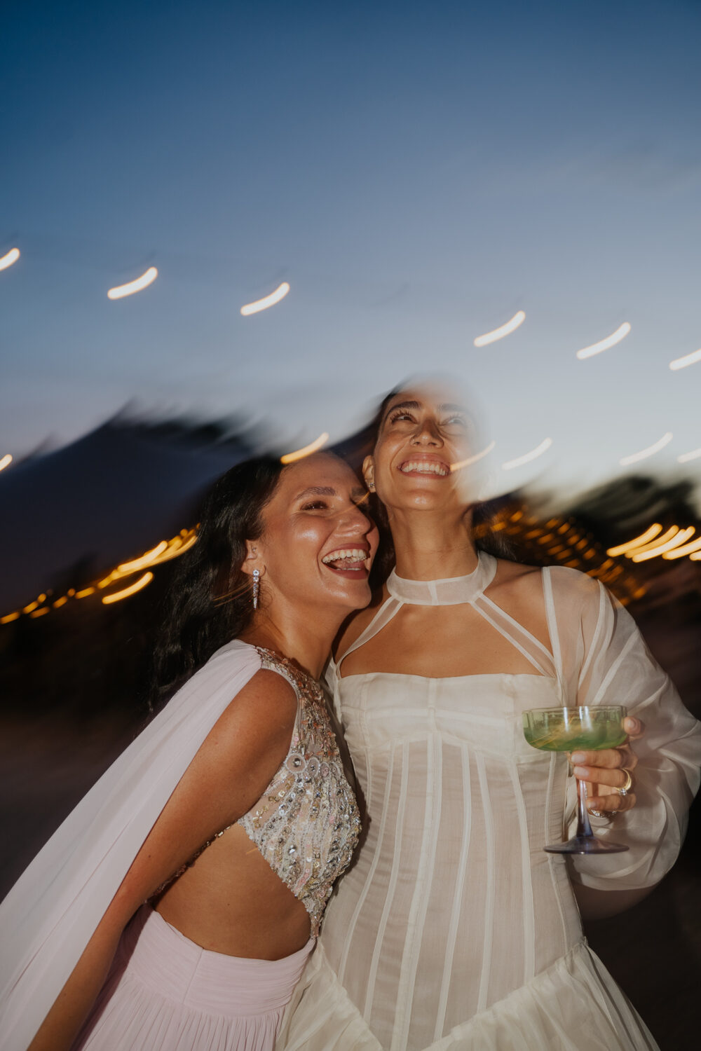 Masseria San Paolo Grande Wedding: Yasemin & Omer's Ostuni Celebration 60 Guests laughing together at dusk during the Masseria San Paolo Grande wedding