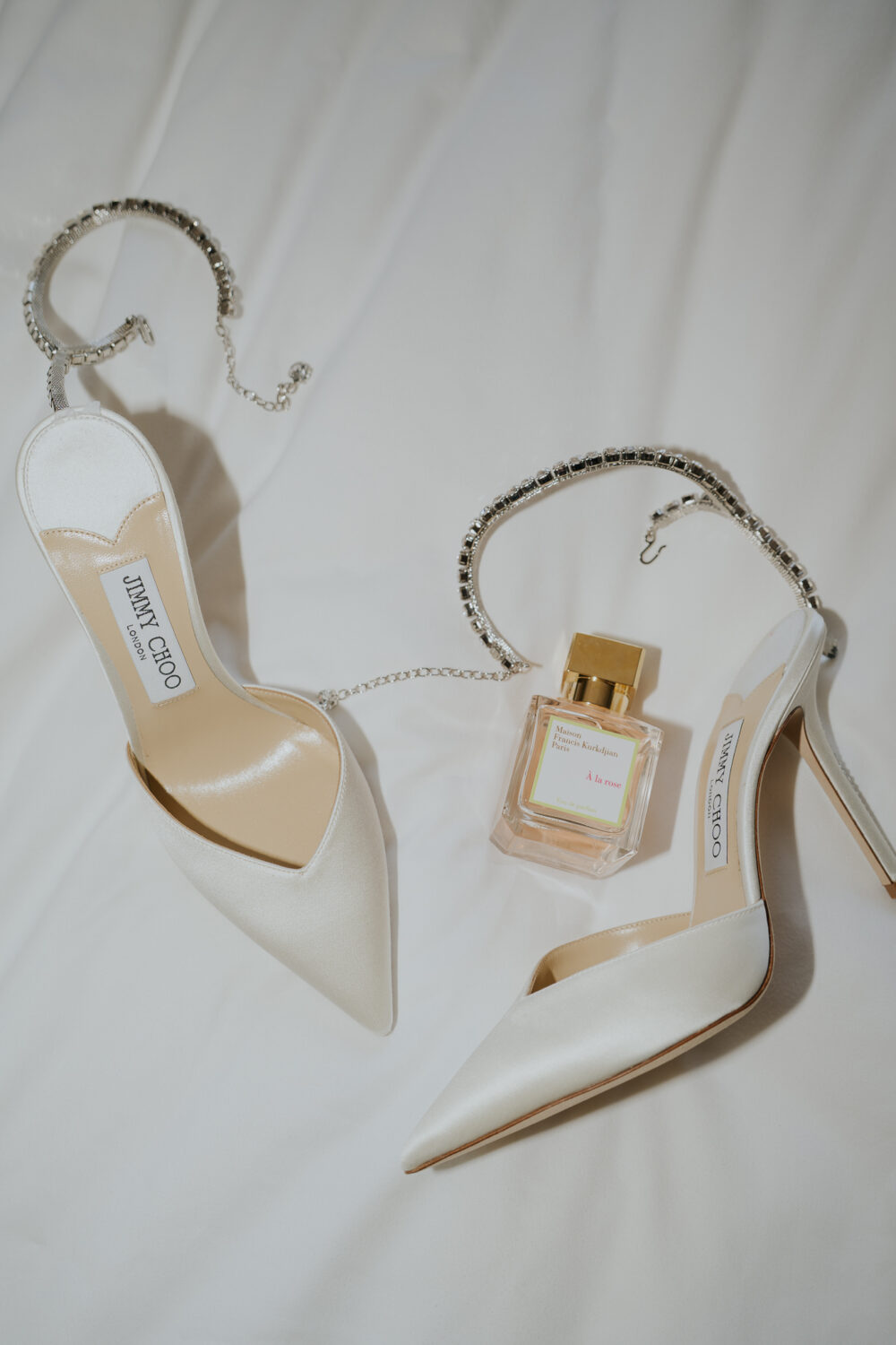 Groom's black patent leather shoes and bow tie laid out before getting ready
