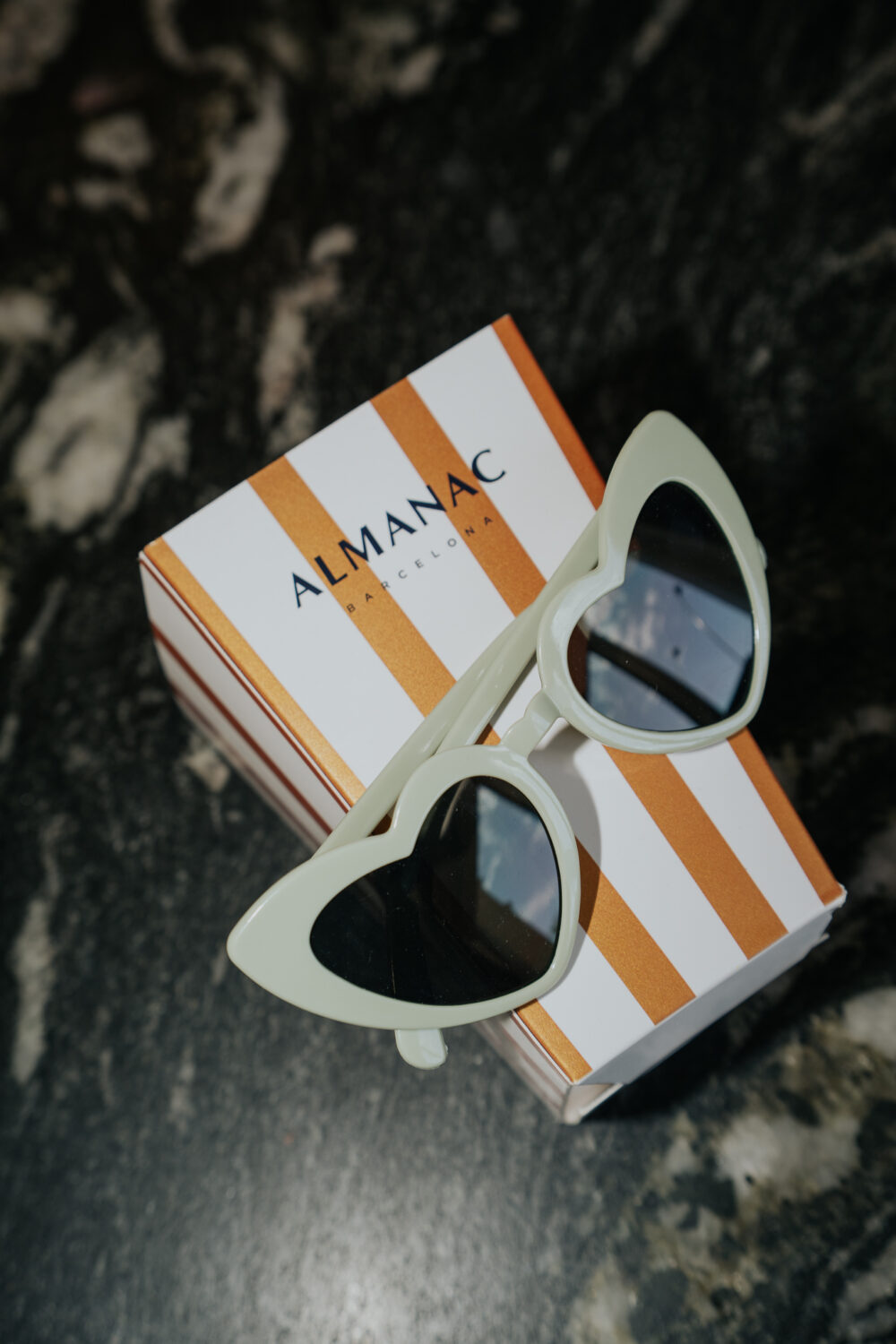 Heart-shaped sunglasses from Almanac Barcelona styled as a wedding welcome gift